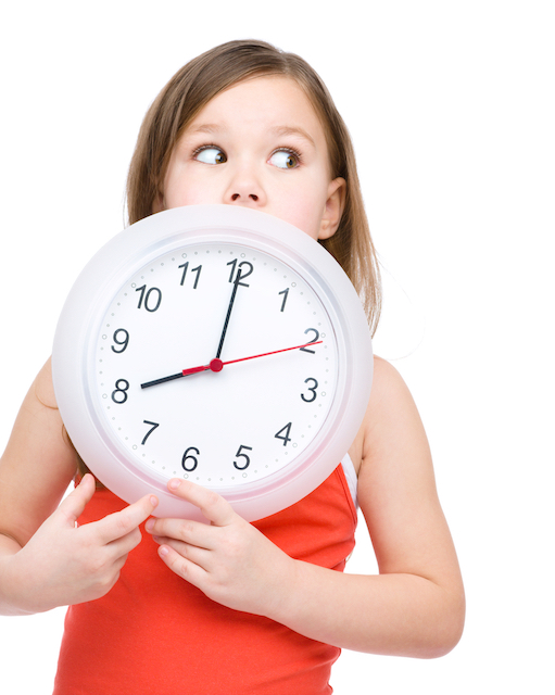 kid holding clock